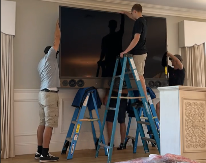 Automated Environment installers mount one of the latest high-end television models in a local home.