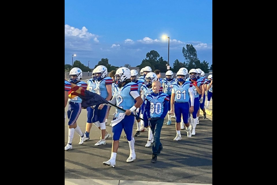 It was a special Friday night under the lights Nov. 4, 2022 in Queen Creek as the Crismon High School football team made Braydon, 13, honorary captain for the evening.