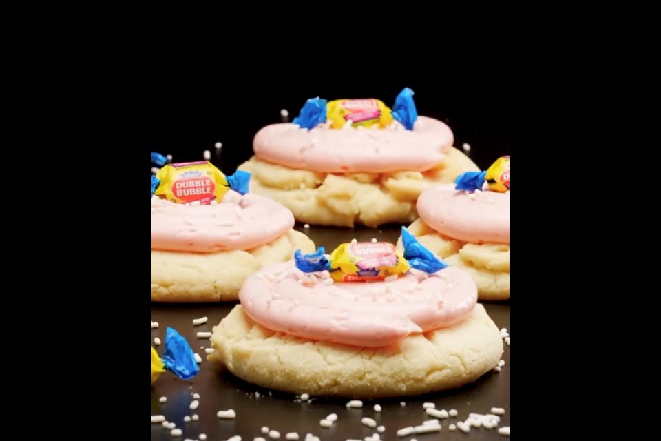New Bubble Gum - A warm vanilla sugar cookie topped with a mellow bubble gum pink frosting, white sprinkles and a real bubble gum piece.