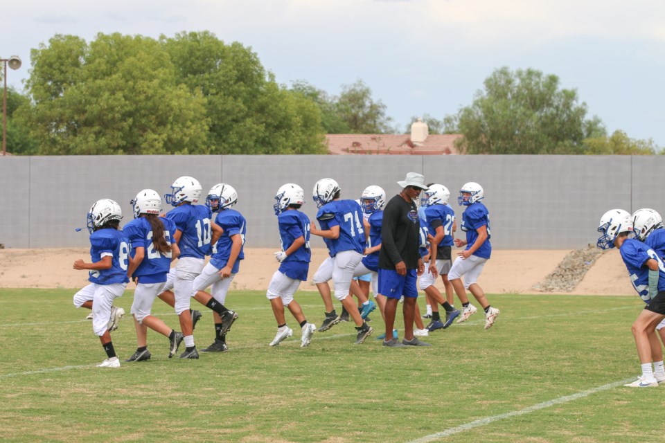 Crismon football players running warm up drills ahead of a practice. The team is made up of freshmen and sophomores and they’ll be playing against varsity competition this season.