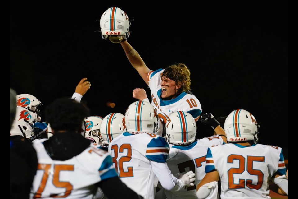 Eastmark teammates lift up their quarterback, Mack Molander, after their 42-21 win over Thatcher Nov. 26, 2022 to win the 3A State Football Championship.