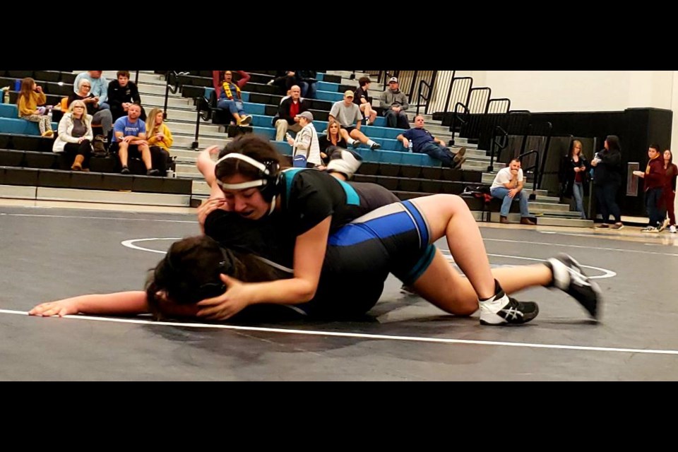 Eastmark sophomore Ariana Oberstein (top) works for a pin on her way to a technical fall versus San Tan Foothills at a recent dual meet.