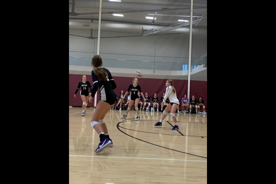 Izzy Mahaffey (white jersey) is one of the starting freshmen on the varsity volleyball team at Queen Creek High School. 