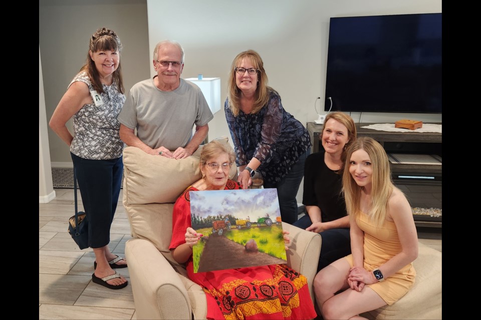 Hospice of the Valley patient Mary Alice Warsco (seated) holding her beloved painting. Behind her are, from left, volunteer coordinator Pat Felton, Mary’s son and daughter-in-law John and Kimberlee Warsco, nurse Emily Irvine and volunteer Mandy Richards.