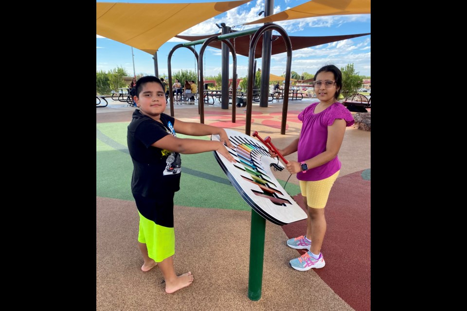 Left to right: Shdya Vest, 10, and Kushi Singh, 9, make a little music together playing the xylophone at Mansel Carter Oasis Park in Queen Creek on Tuesday after a rainy morning during their fall break.