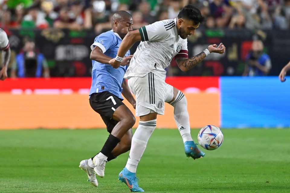 Mexico’s Alexis Vegas takes a touch downfield as he is pressured by Uruguay’s Nicolas de la Cruz in Mexico’s 3-0 defeat to Uruguay at State Farm Stadium on June 2, 2022.