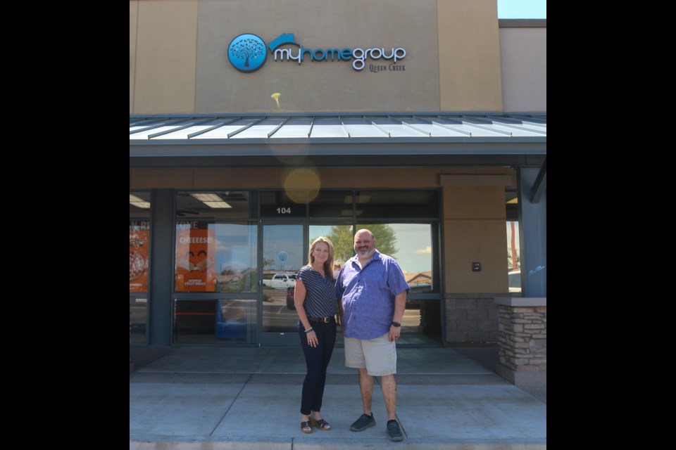 "Big Mike" Hernandez and My Home Group Queen Creek office manager, Michelle Cordes outside of their office. My Home Group is currently one of the highest selling brokerages in Arizona this year.