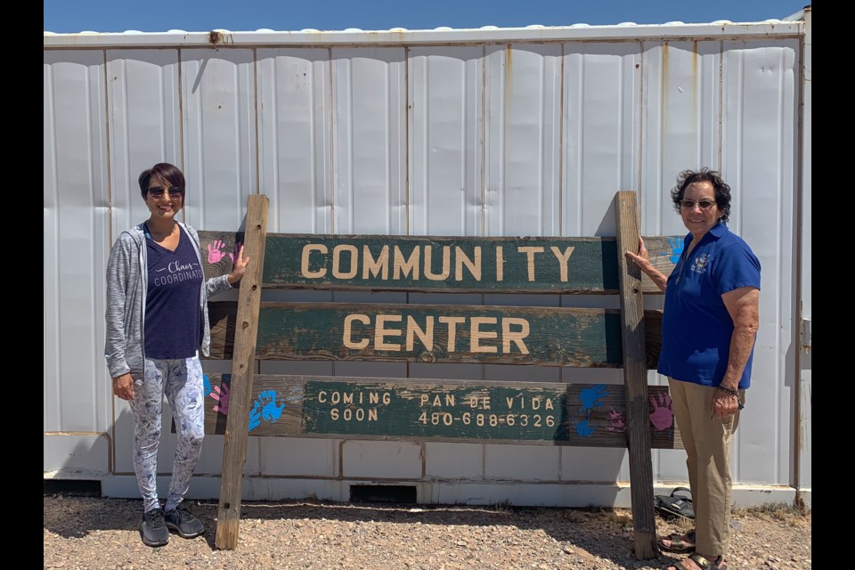 Pan de Vida founder Mary Gloria, right, and her daughter Kelly, left, stand outside one of the shipping containers holding various donations from the community. Mary founded the foundation back in 2003 and it just celebrated its anniversary.