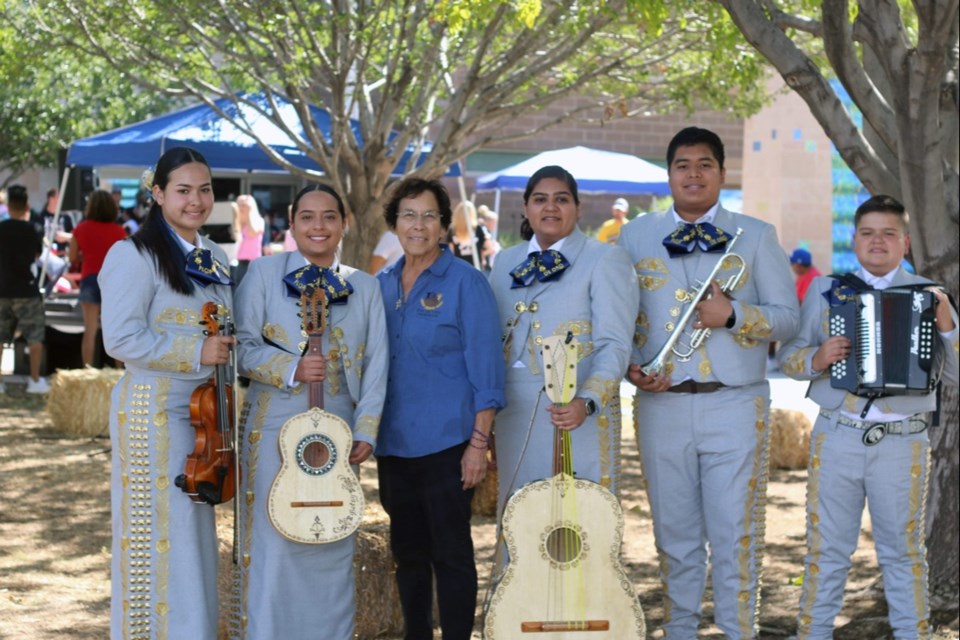 Mary Gloria, founder of Pan de Vida, stands with a band from a previous health fair.