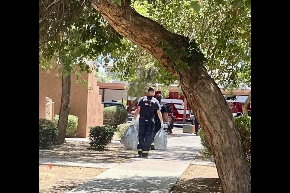 After treating the elderly gentleman in the extreme heat, the Queen Creek firefighters decided to grab all of his trash bags and helped clean up the man's property.