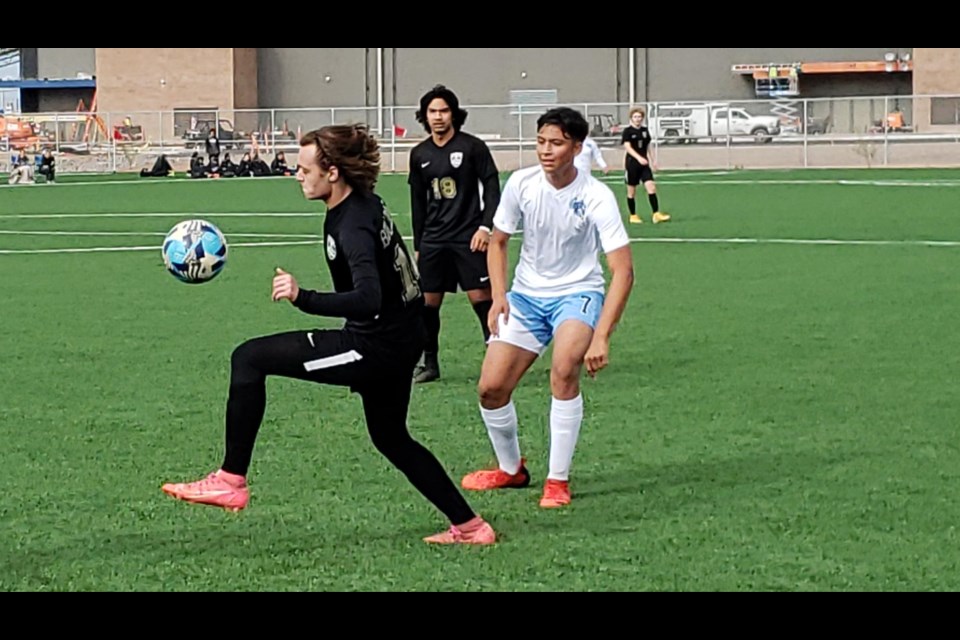 Queen Creek High junior Jack Robinson controls a loose ball deep into the Cobra defensive zone in a 1-1 tie during the Arizona Showcase tournament at Bell Bank Legacy Park on Dec. 28, 2021.