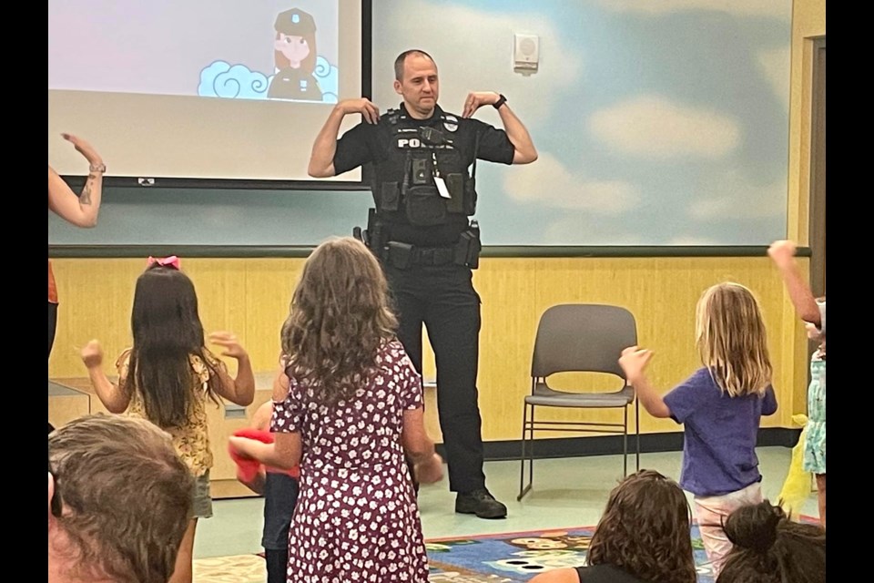 Queen Creek Police Lt. Mark Newman took a quick break yesterday, July 6, to play a game of Simon Says and read "The Book With No Pictures" to children at the Queen Creek Library as part of the "Read with a Cop" program.