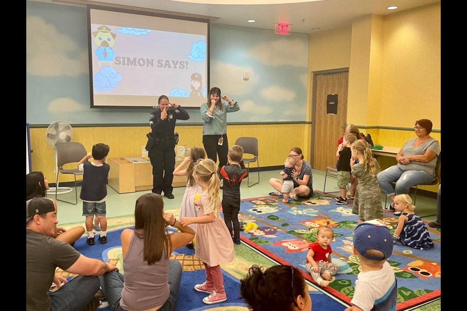 Queen Creek Police Department Sgt. Megan Erwin takes part in the Read with a Cop program at the Queen Creek Library in September 2022.
