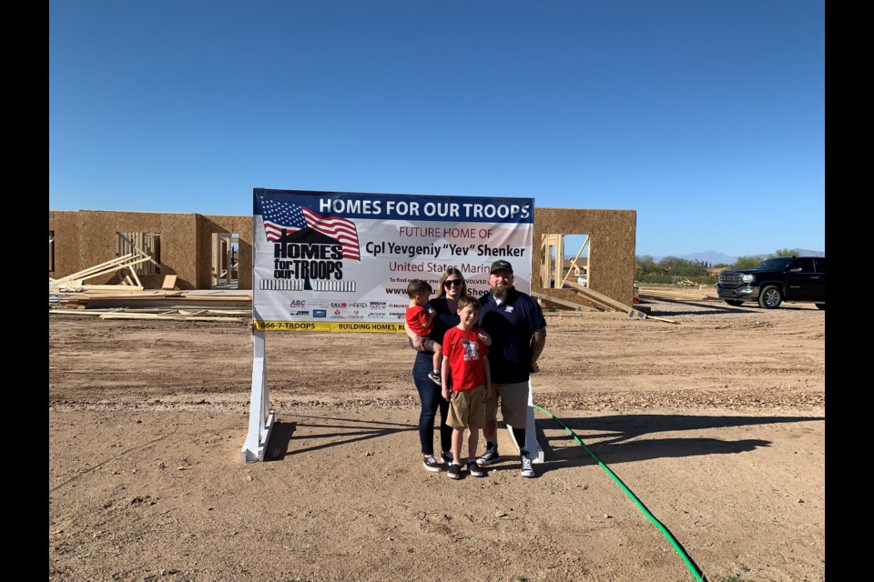 Retired U.S. Marine Cpl. Yevgeniy "Yev" Shenker and his family in front of their future home in Queen Creek on April 2, 2022.