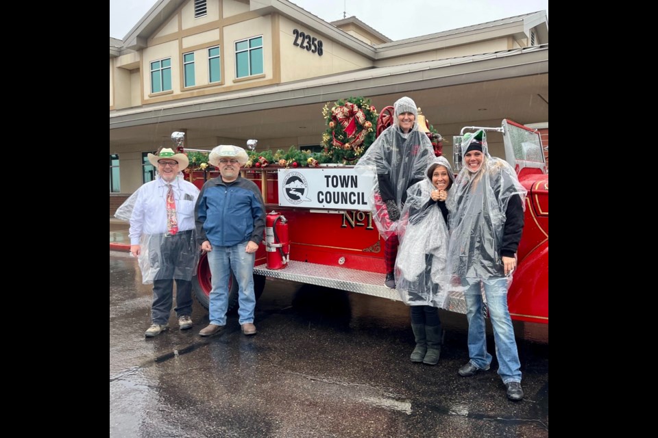 Queen Creek Town Council members brave the rainy weather at the 40th Annual Queen Creek Holiday Festival & Parade Dec. 3, 2022.