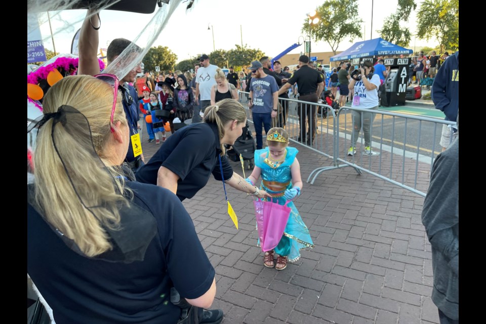 Queen Creek Police Department officers at their trunk handing out candy at the town's Trunk or Treat event on Oct. 16, 2021.