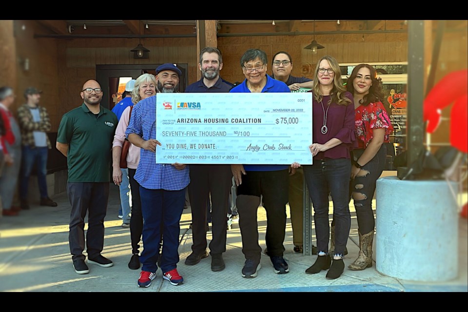 Angry Crab Shack representatives presenting the Arizona Housing Coalition’s Arizona Veterans StandDown Alliance with a check after last year's "You Dine, We Donate" campaign.