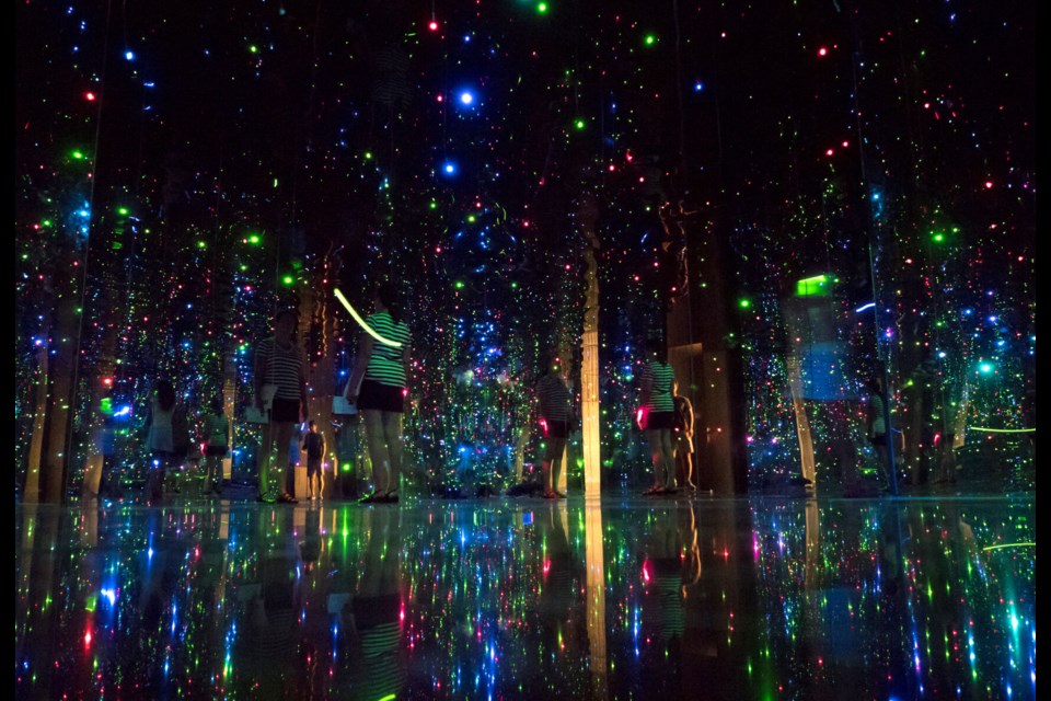 Yayoi Kusama's "You Who are Getting Obliterated in the Dancing Swarm of Fireflies," (2005) a mixed media installation with LED lights.