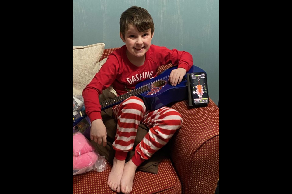 Nine-year-old Charlie Macklin received a guitar from the "Steveston elf" on Christmas morning.