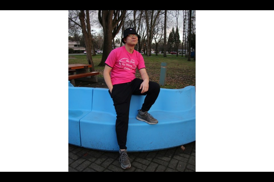 MacNeill student Botao Chen wearing his winning t-shirt design for Pink Shirt Day 2023.