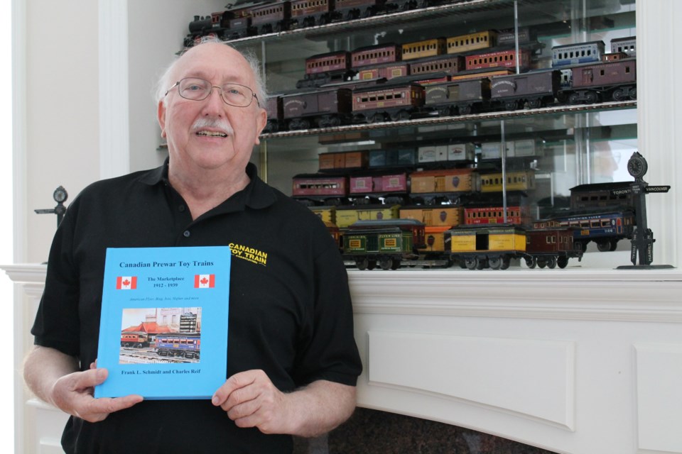 Richmond resident Frank Schmidt with his recently published book on the Canadian toy train retail industry.