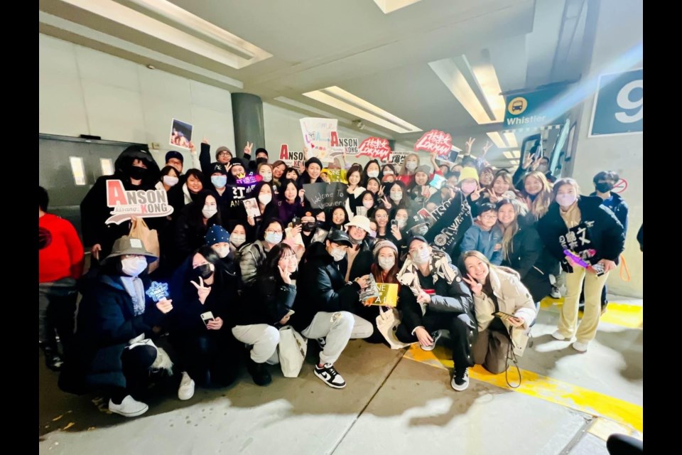 Lokman Yeung and Anson Kong posing with fans at YVR on Wednesday night.