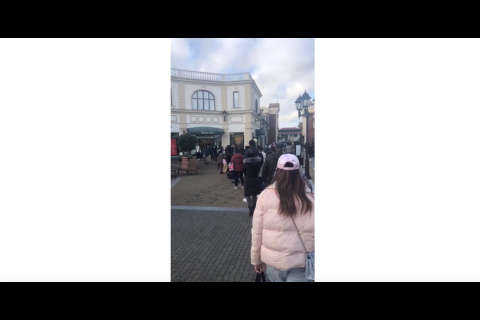 People are lining up in front of the Michael Kors store at McArthurGlen. 