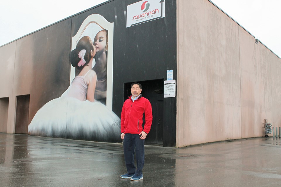 Winston Sayson with the ballerina mural in Richmond painted by artist Paul Archer.