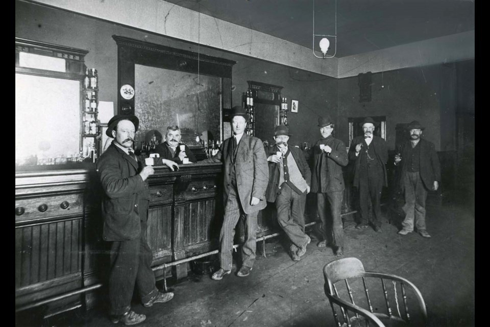 Five dapper-looking gents pose for a photo while having a drink at the Steveston Hotel in 1910