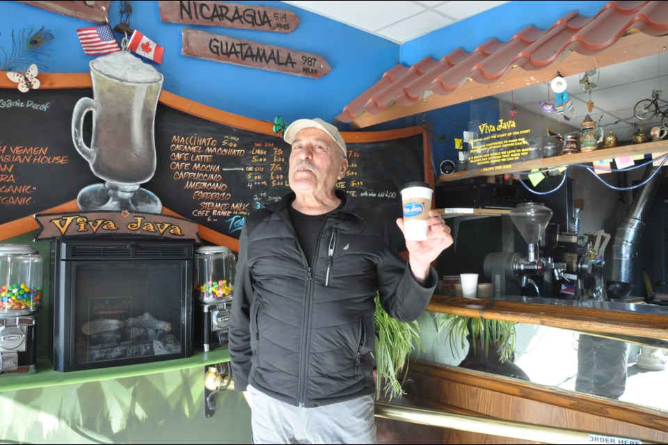 Arturo Hagop, owner of Viva Java coffee shop in Richmond, serves coffee from coffee beans he freshly roasts every day. 