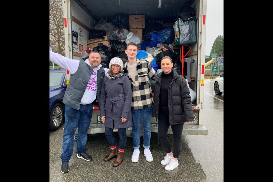 Angela Dinnell (right) and Chris Dinnell (left) with helpers at Saturday's clothing drive for the local homeless shelter