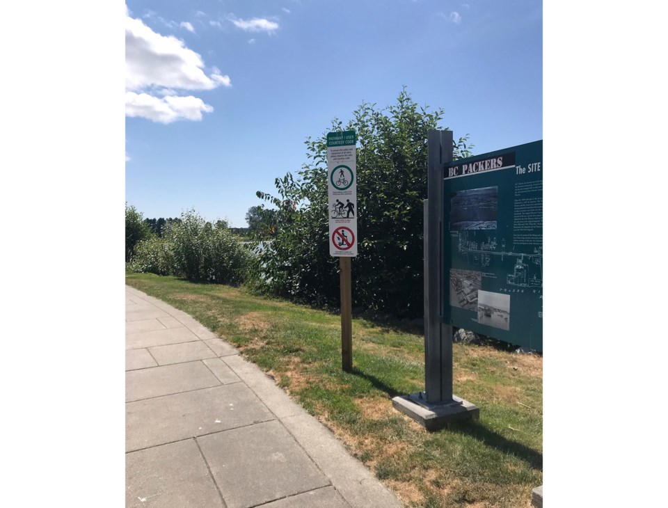 Cycling signs at Steveston Imperial Landing boardwalk