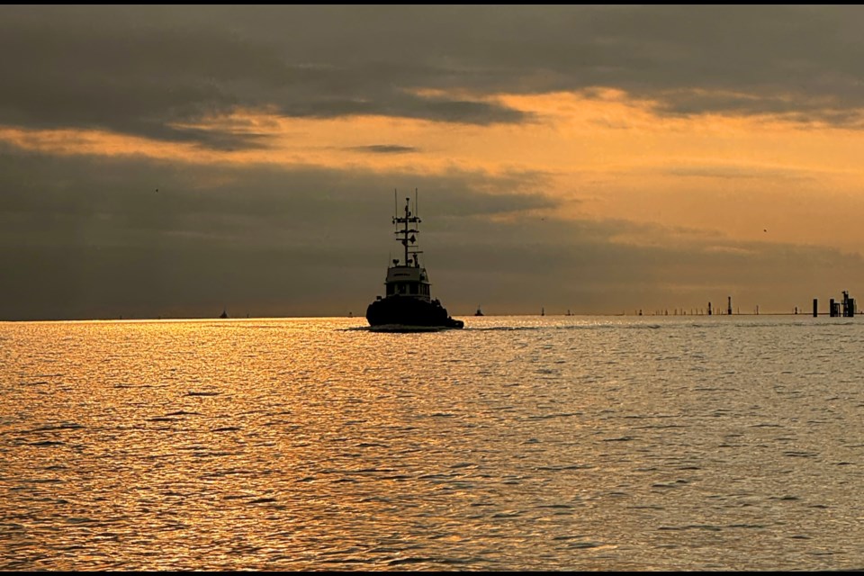 A tugboat on the river just before sunset.