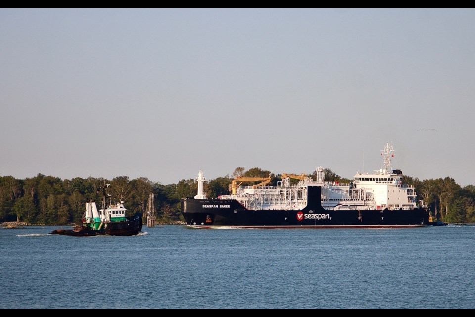 The MV Seaspan Baker is crossing paths with Tubgoat Alison Nicole along the south arm of the Fraser River.