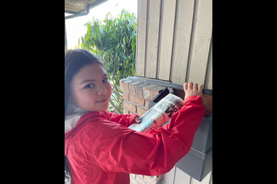 Esmé Li, who took over the newspaper carrier role this year, is delivering the Richmond News newspaper. 