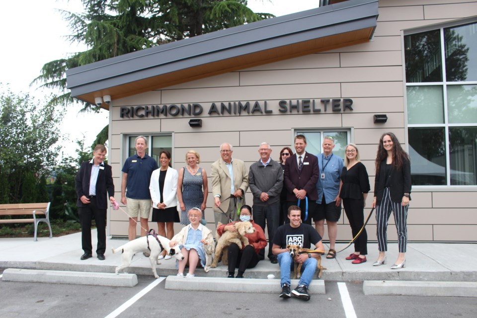 Mayor Malcolm Brodie, city council members, and community members including Richmond students posed with four-legged companions for a photo at the official opening of the new Richmond Community Animal Shelter.