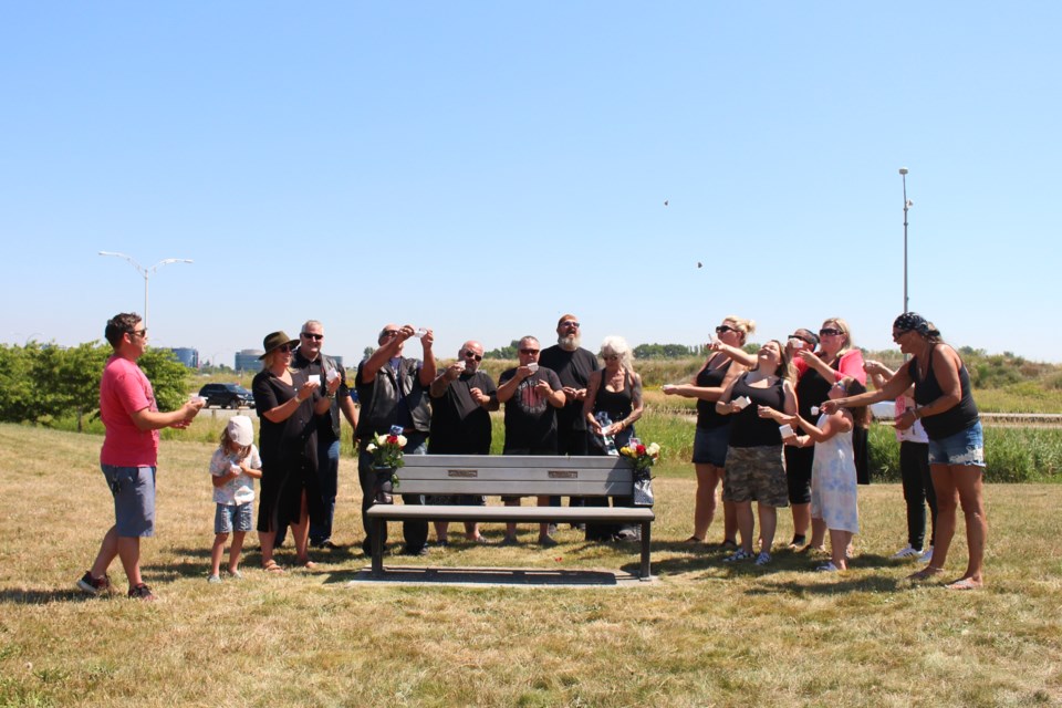 Friends and family gathered at the bench dedicated to Christy Mahy to release butterflies on the eighth anniversary of her passing.