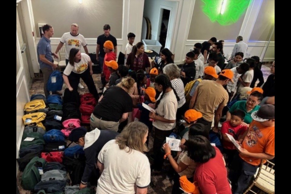 Backpacks filled with school supplies were handed out to 75 kids last week at Riverside Palace Banquet Hall.