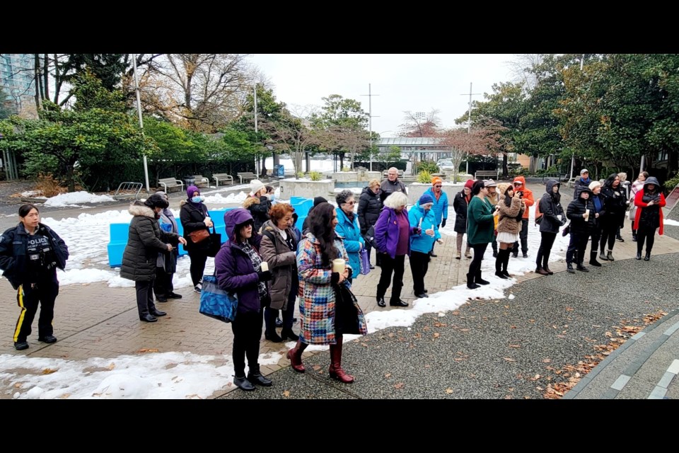 A vigil was held outside Brighouse library on Tuesday to commemorate the victims of the 1989 Montreal Massacre.