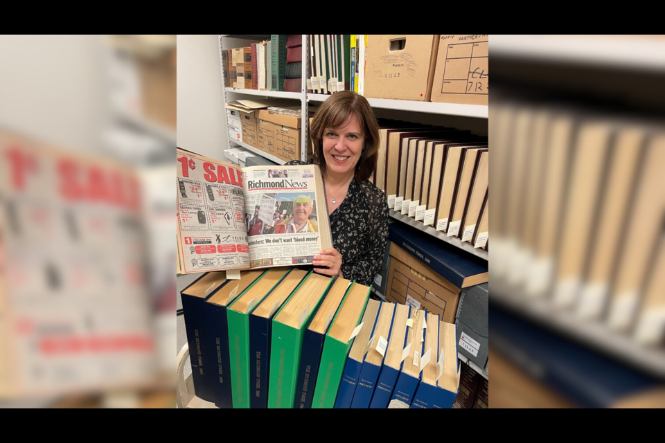 City archivist Dovelle Buie shows old News copies. 