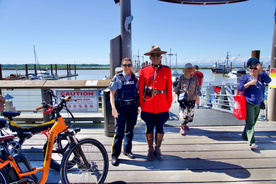 Police officers on serving the public at Fisherman's Wharf in Steveston.