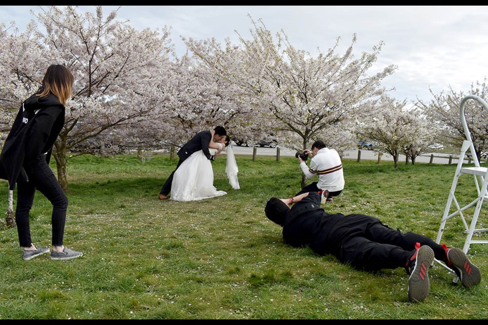 A bride and groom were having their wedding photos taken at the Larry Berg Fight Path Park on Monday.