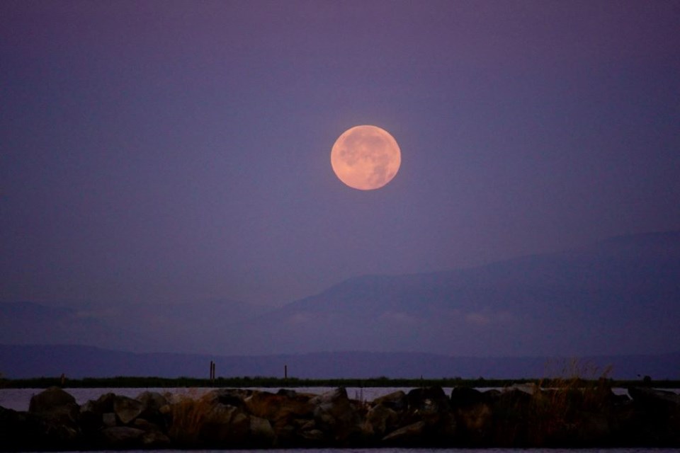Sturgeon Moon as seen from Fisherman's Wharf in Steveston in the early morning on Sunday.