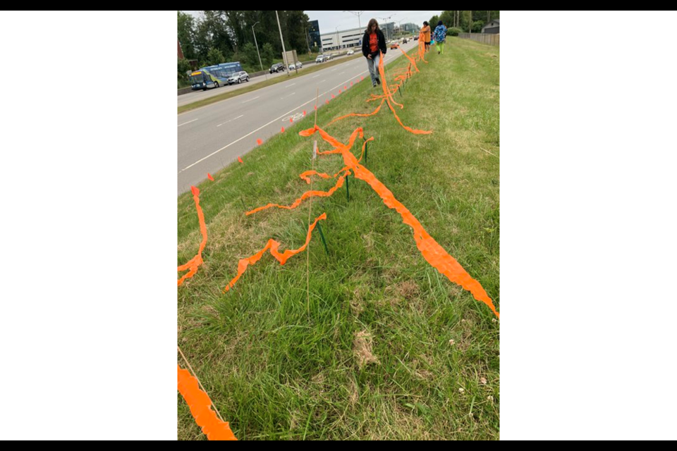 Orange ribbons have been placed along Russ Baker Way in Richmond in memory of 215 children found in unmarked graves at the former Kamloops Indian Residential School.