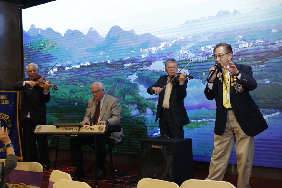 The fundraiser features live music and dance. Performers from left to right: musician Dan Song, the city of Richmond mayor Malcolm Brodie, violinist Kan Chan, and Syrus Lee. 