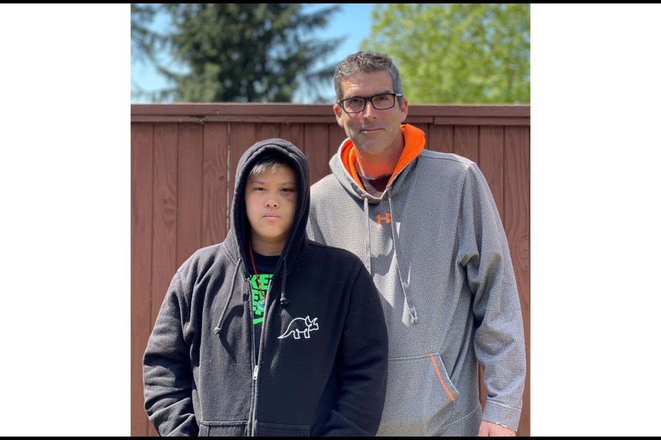 Janice Xie, 14, at home with her father, Tim Sorensen. She is still spending her days at home, sleeping on and off, after she was beaten unconscious by an older male student at Hugh Boyd secondary