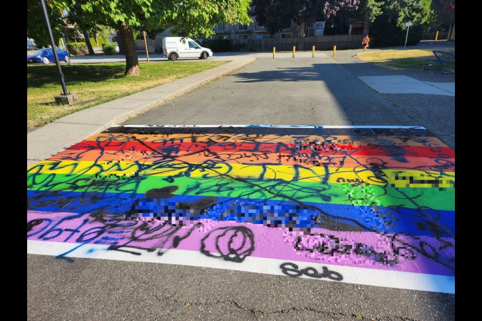 The newly installed rainbow crosswalk outside Palmer secondary was defaced with homophobic graffiti. Photo submitted