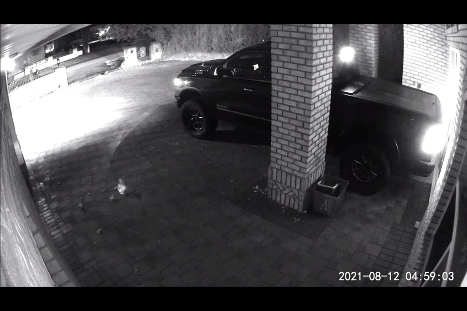 Security footage showing a black pick-up truck trying to force through the front door of a home.