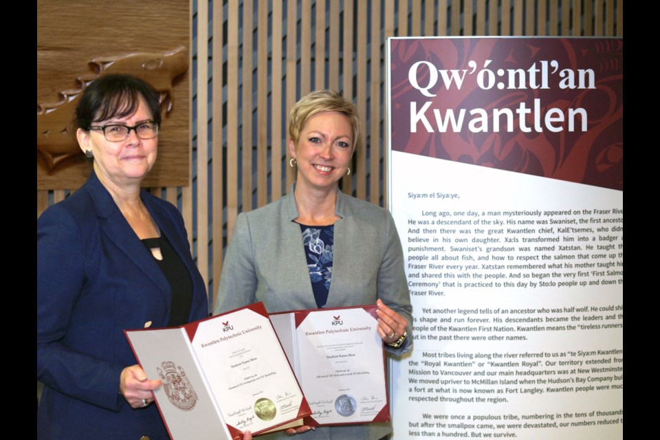Natalie Wood-Wiens and Zena Mitchell posing with the new diplomas.