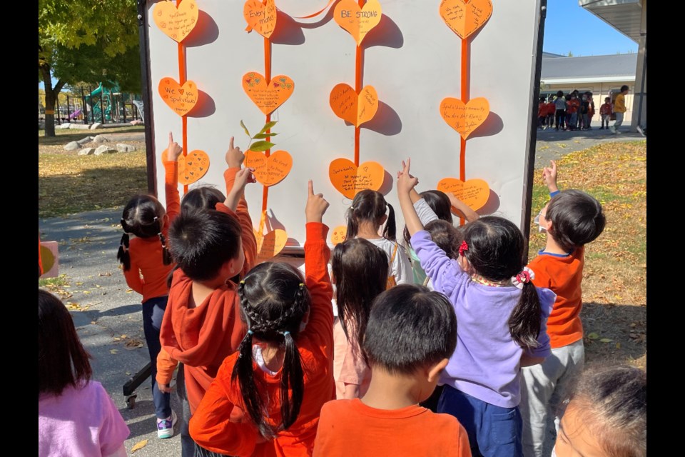 Students at Spul'u'kwuks elementary reflected on messages written on orange hearts after their Truth and Reconciliation symbols were pulled down.